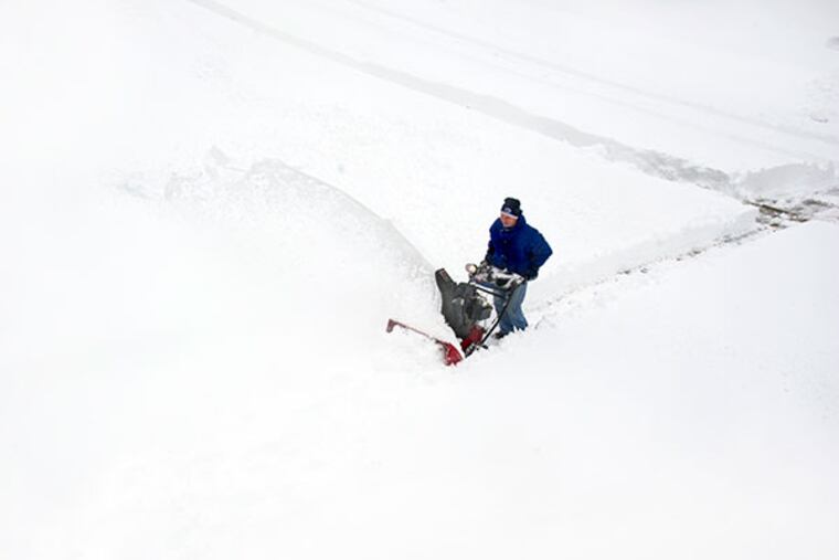 Dave Ennis, 54, guides his snowblower to clear his neighbor's driveway in the Hopewell development of East Brandywine Feb. 13, 2014. The winter Nor'easter dumped about 15 inches of snow in the neighborhood. ( CLEM MURRAY / Staff Photographer )