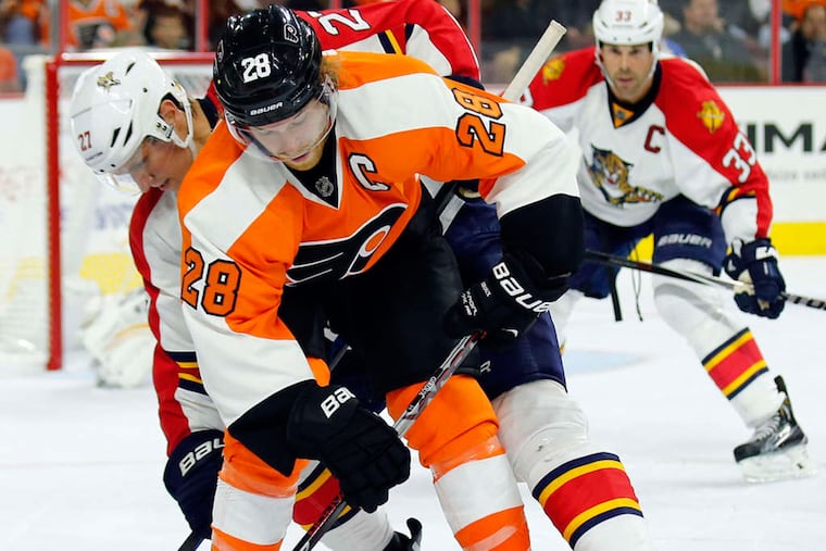 Claude Giroux watches the puck against Florida Panthers' Nick Bjugstad.