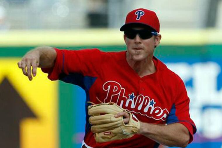 Chase Utley throws the baseball to first base after a force out at second base in the first-inning during a spring training intrasquad game in Clearwater, FL on Friday, February 22, 2013. (Yong Kim/Staff Photographer)