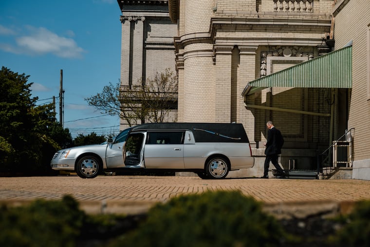 Nick Cassese puts cremated remains in a hearse outside the Fresh Pond Crematory and Columbarium in Middle Village, N.Y., a stately yellow brick building from 1884 in the New York City borough of Queens.