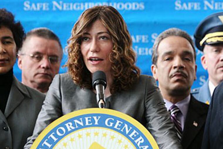 N.J. Attorney General Anne Milgram, accompanied by county prosecutors and other members of law enforcement, speaks at a news conference announcing that an anti-gang initiative has netted more than 1,800 arrests as well as the seizure of narcotics and guns. (AP Photo/The Record, Chris Pedota)