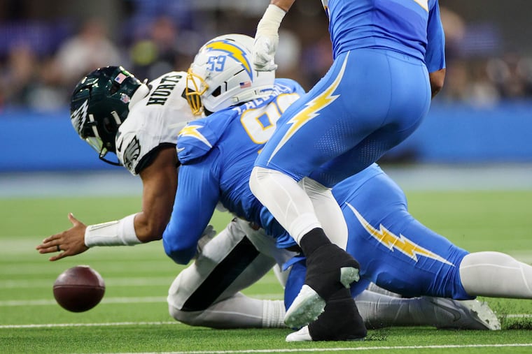 In the middle of Jalen Hurts' awful game: The Chargers' Jamaree Caldwell strips the ball from him after the Eagles QB recovered it on a wacky second-quarter play.