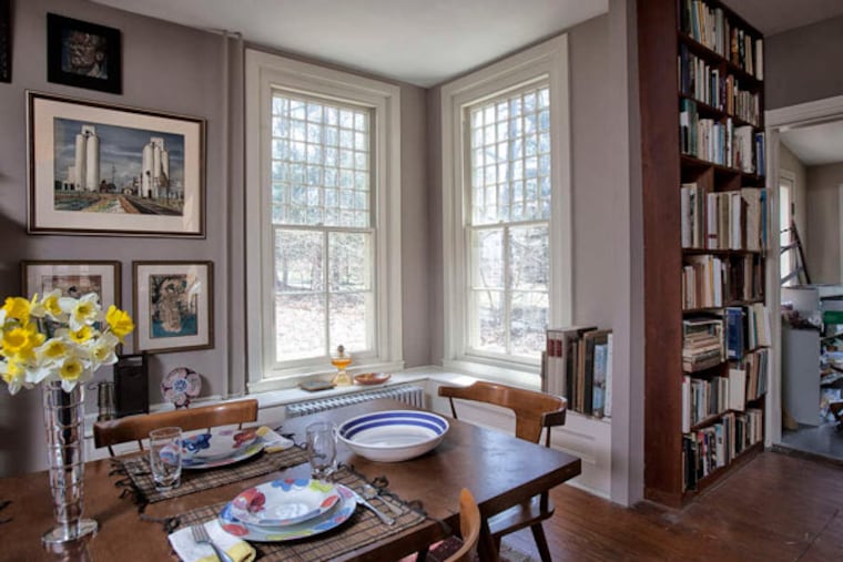 The bright, window-filled dining room. The vintage windows, each featuring 36 small panes over four large ones, fill the house with light.