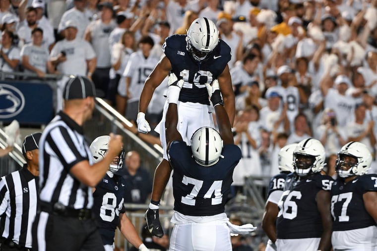 Penn State running back Nicholas Singleton (10) celebrates a touchdown against West Virginia with offensive lineman Olumuyiwa Fashanu (74) during the first half of the Nittany Lions' 38-15 season-opening win.
