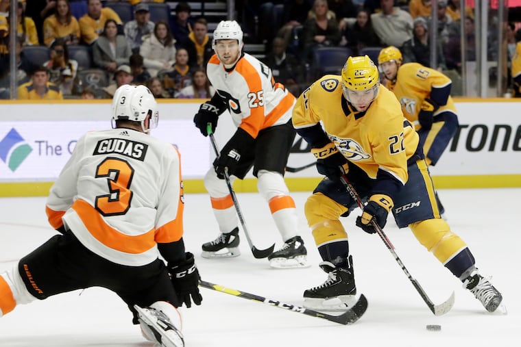 Radko Gudas tries to block a shot by Predators left wing Kevin Fiala during the second period.