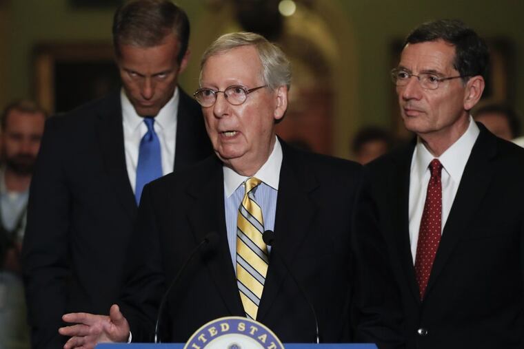 Senate Majority Leader Mitch McConnell, R-Ky., joined by Sen. John Barrasso, R-Wyo., right, and Sen. John Thune, R-S.D., left, speaks during a news conference on Capitol Hill in Washington, Tuesday, June 27, 2017.