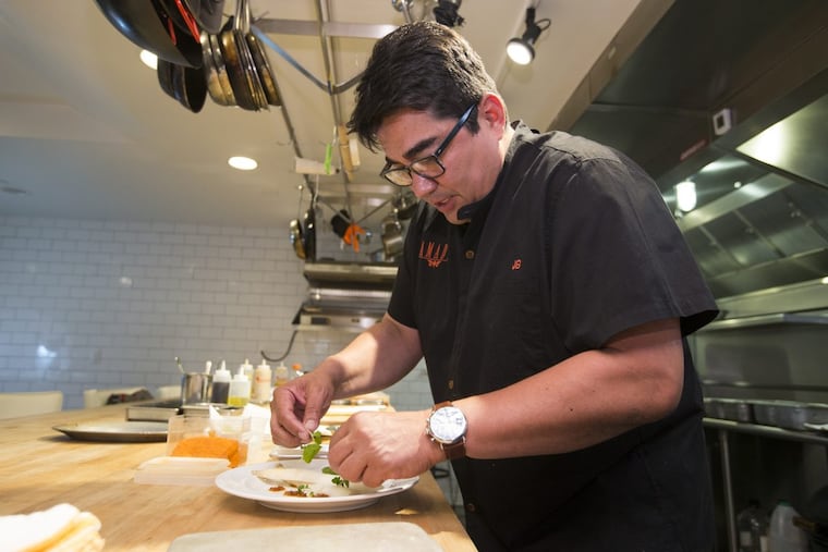 Jose Garces working in his test kitchen at 2401 Walnut St.