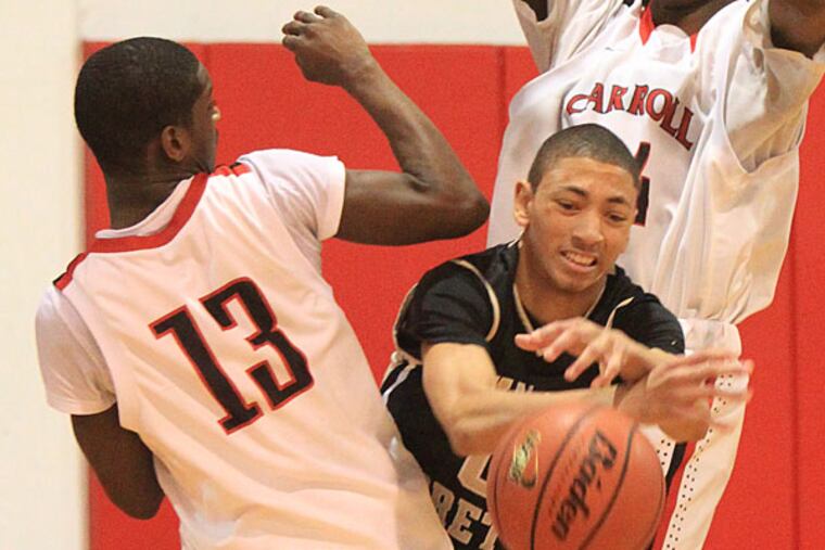 Neuman-Goretti's Vaughn Covington (center) loses the ball as he is trapped in the backcourt by Carroll's Samir Taylor (left) and Derrick Jones. (Charles Fox/Staff Photographer)