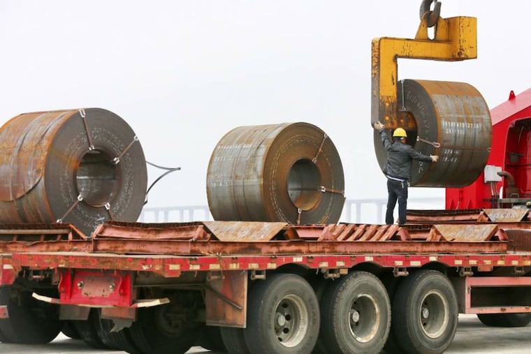 In this May 19, 2018, photo, a worker positions a roll of steel plate at a dockyard in Qidong in eastern China's Jiangsu province. China appealed Friday, June 1, 2018, to its trading partners to reject "trade and investment protectionism" after Washington raised tariffs on steel imports and said it will impose curbs on Chinese investment.