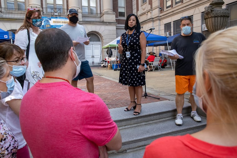 Evelyn Nuñez (center), Philadelphia School District chief of schools, ordered Masterman teachers working outside to go into the building. The teachers said they would not do so until they got answers about their asbestos concerns.