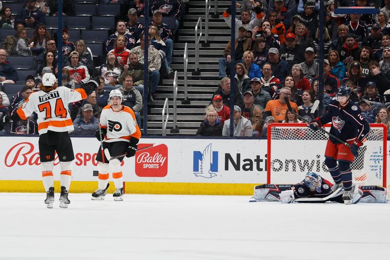The Flyers' Noah Cates, second from left, celebrates his goal against the Columbus Blue Jackets with teammate Owen Tippett during the second period Thursday in Columbus, Ohio.