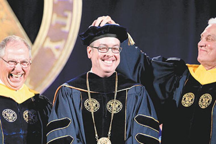 Chuck Pennoni, left, vice chairman of the Drexel University Board of Trustees and immediate past interim president, and Trustees Chairmn Richard A. Greenawalt, right,have a good laugh after the Investiture on John A. Fry, center, as the 14th President of Drexel University. (Charles Fox / Staff Photographer)