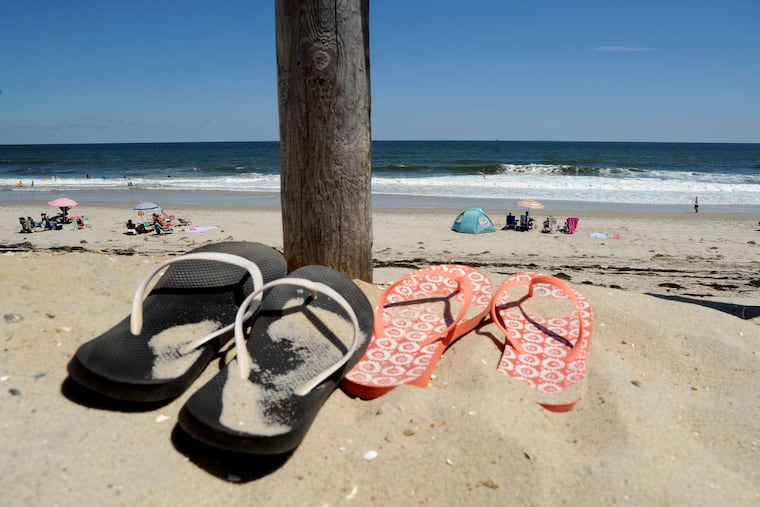 Flip-flops are left on the edge of the dunes for a walk to the beach in Harvey Cedars on Long Beach Island.