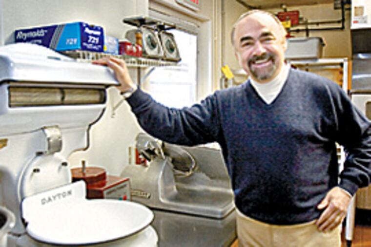 With a dicey economy cutting profits, owner Jack McFadden weighs provisions delivered to the Gables at Chadds Ford. (Ed Hille/Inquirer)