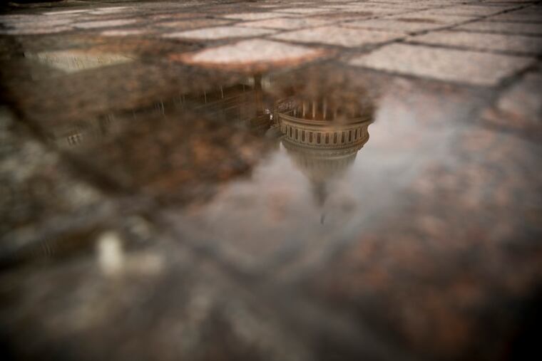 In this Feb. 22, 2019, file photo the dome of the U.S. Capitol Building is visible in reflection in Washington. On Friday, March 22, the Treasury Department releases federal budget data for February.
