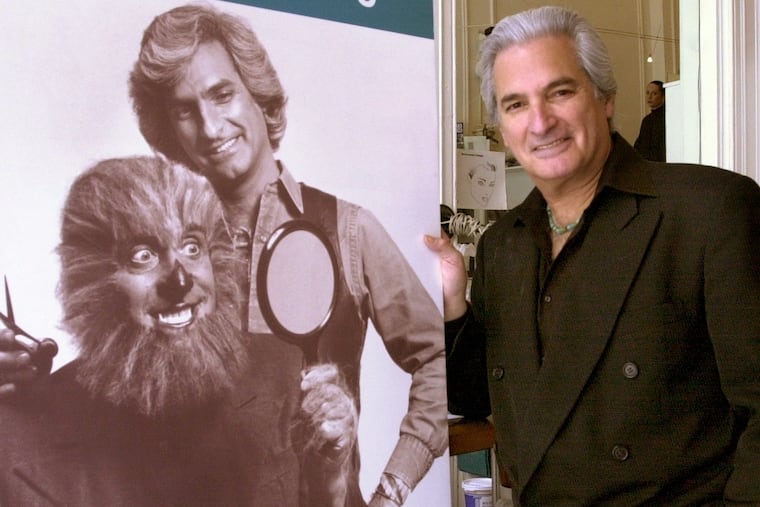 Mr. Leonard stands next to one of his signature ads at his Chestnut Street salon in 2002.