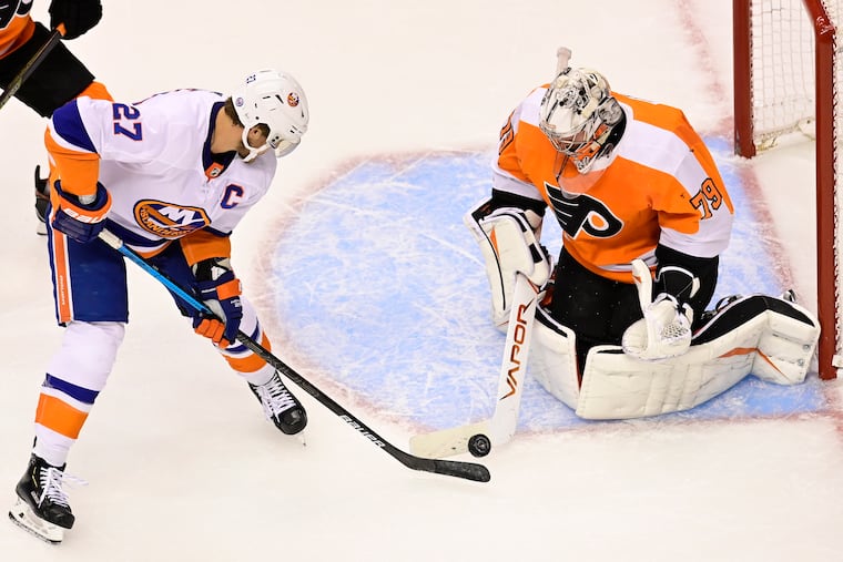 Flyers goaltender Carter Hart makes a save against Islanders left winger Anders Lee during a Stanley Cup playoff game in September. The NHL is hoping to return in mid-January.