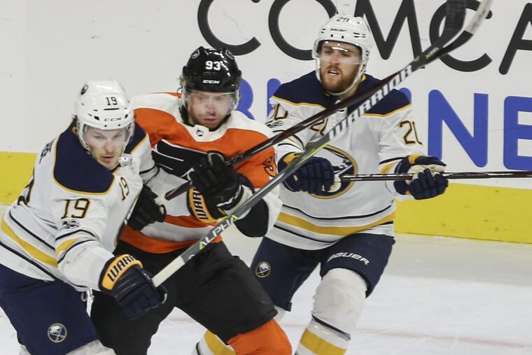 Jake Voracek (center), battling against two Sabres in a recent game, entered Wednesday as the NHL’s fifth-leading scorer.