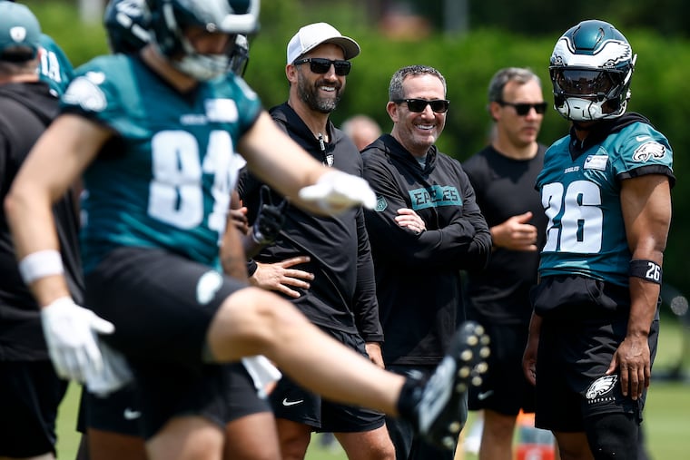 Eagles GM Howie Roseman (center-right) has been active in the trade market in recent Augusts. As camp progresses, will he make another deal?