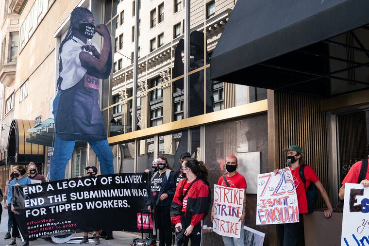Restaurant workers in Philadelphia demonstrate at Broad and Chestnut Streets demanding a $15 minimum wage for all workers.