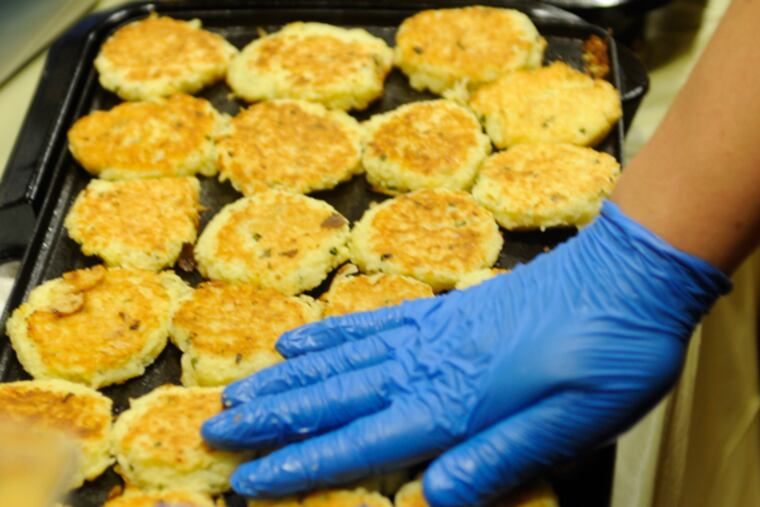 Chris Lashiy cooks up latkes at the 12th annual — and sold-out — Latkepalooza at the Gershman Y. December 7, 2014. (TOM GRALISH/Staff Photographer)