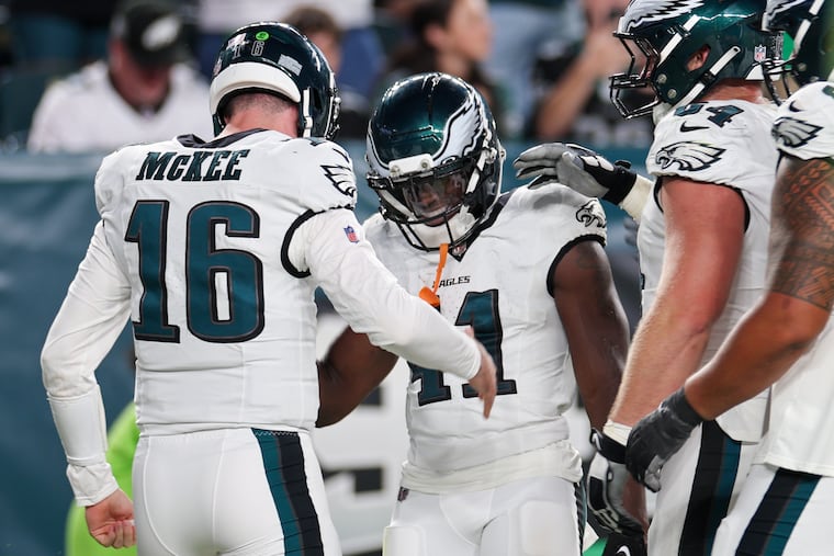 Eagles quarterback Tanner McKee celebrates a touchdown pass with Eagles wide receiver Darius Cooper late during the second quarter in a preseason game against the Bengals on Thursday, Aug. 7, 2025, in Philadelphia.