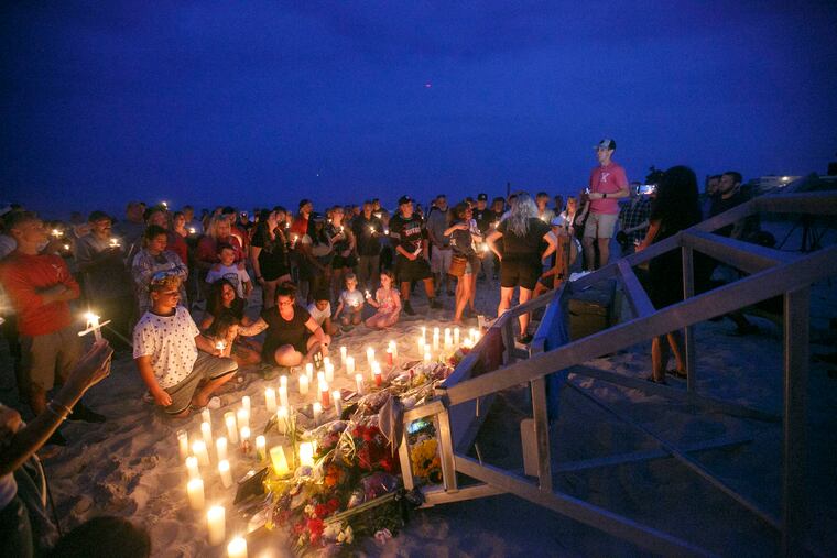Tyler Pinto speaks to the crowd of family, friends and community members who showed up to a vigil for his brother Keith in Berkeley Township.