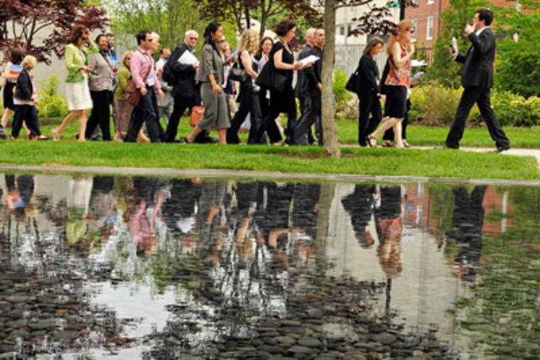 A guided tour passes the reflecting pool outside the new Benjamin Franklin Parkway campus of the Barnes Foundation as the Impressionist and Modernist gallery holds an opening press preview May 16, 2012. International media and critics, building paparazzi, art poohbahs, and the local working press converged on the new Barnes gallery, as it prepares to open May 19. No ids. ( TOM GRALISH / Staff Photographer )