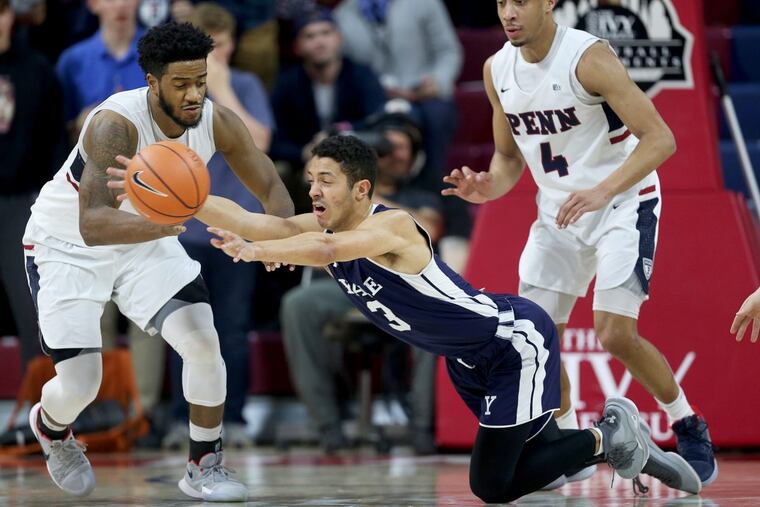 Yale guard Alex Copeland (3) throws a pass as he falls in front of Penn guard Antonio Woods (2) during their Ivy League tournament semifinal game at the Palestra on Saturday. Penn won, 80-57.