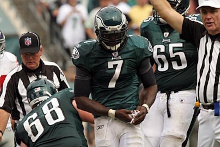 Michael Vick injured his right hand during Sunday's loss to the Giants. (Yong Kim/Staff Photographer)