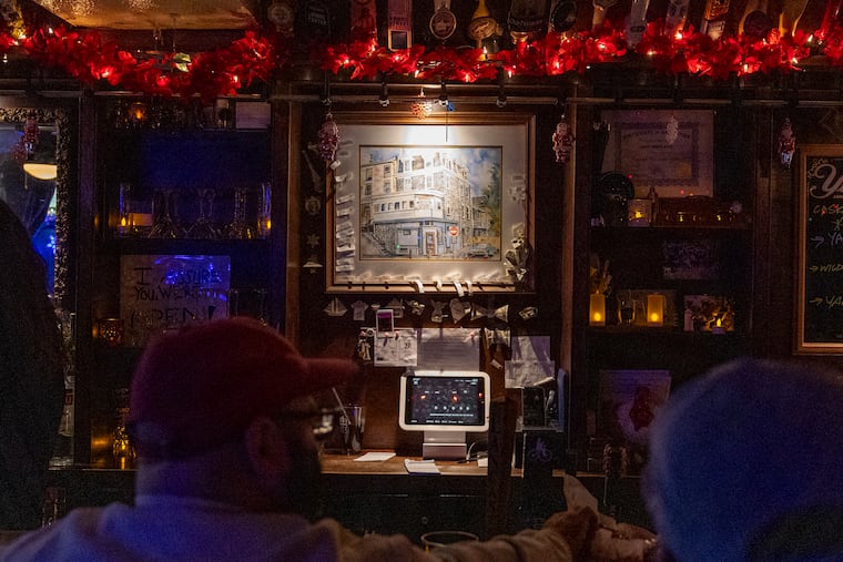 A watercolor painting of Dawson Street Pub done by local artist Jerry Tierney in 1995, is displayed behind the bar in Philadelphia on Friday, Dec. 19, 2025.