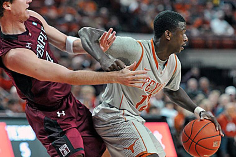 Temple guard Juan Fernandez, left, gets tangled up with Texas guard Myck Kabongo. (AP Photo/Michael Thomas)