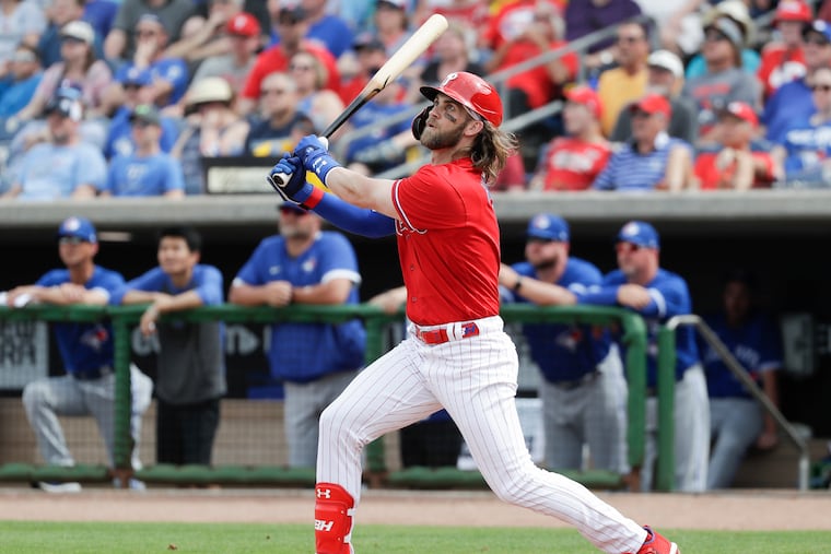 Phillies Bryce Harper watches his fifth-inning, two-run home run against the Toronto Blue Jays in Clearwater on Thursday.