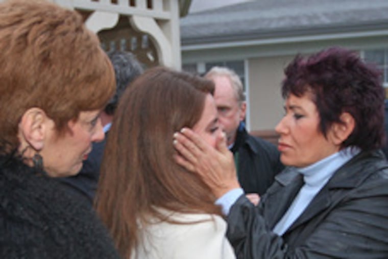 Luann Dubin, a friend of Ellen Gregory Robb's, embraces Lauren Gregory, Robb's niece. At left is Maryann Jones, ex-wife of Art Gregory, one of Ellen Robb's brothers.