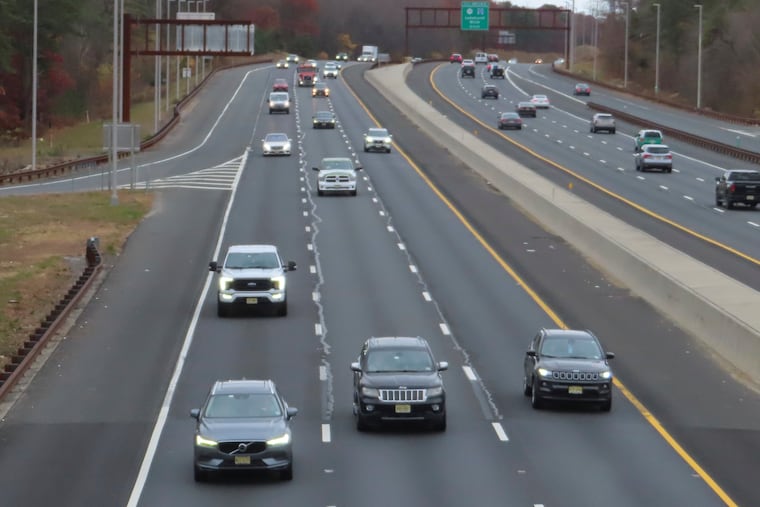 Cars drive on the Garden State Parkway in Brick, N.J. on Tuesday the same day that New Jersey officials said they will move to end the sale of new gasoline-powered vehicles in the state by 2035.