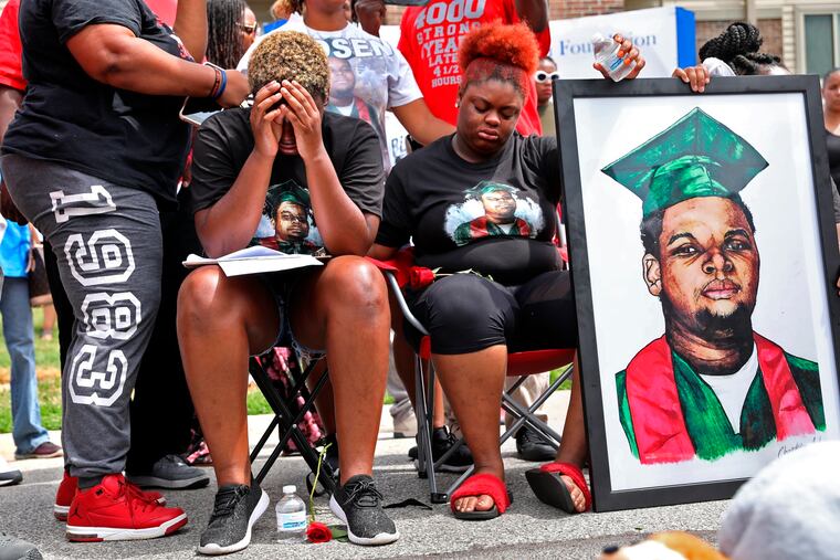 In this 2018 file photo, Trinetta Brown, center left, 19, and Triniya Brown become emotional during a memorial service for their brother, Michael Brown