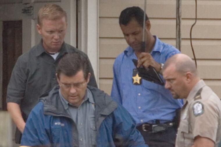 In Oxford, Fla., police remove a Burmese python from a home, where it escaped from a terrarium and strangled a 2-year-old girl in her bedroom on July 1, 2009.