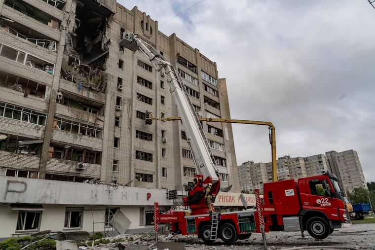 Firefighters put out a fire after a residential building was hit following Russia's drone attack in Kharkiv, Ukraine, Sunday, Aug. 9, 2026.