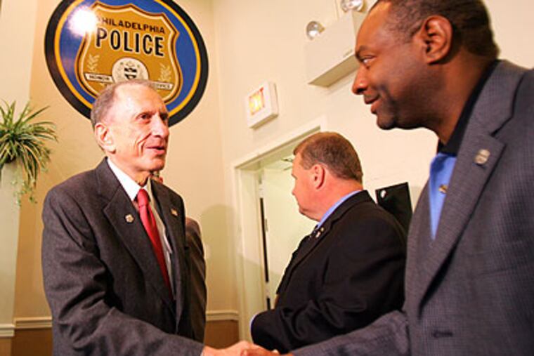 Sen. Arlen Specter greets Roosevelt Poplar, vice president of FOP Lodge #5, Friday. (David Swanson / Staff Photographer)