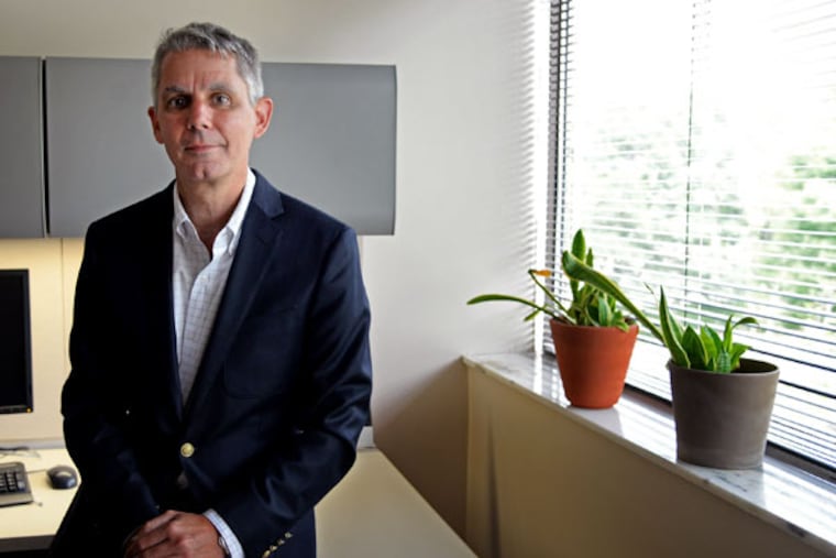 David Casarett in his Bala Cynwyd office. He felt he had to sample the wares before he could decide on marijuana. (TOM GRALISH / Staff Photographer)