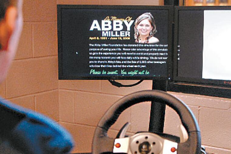 Abby Miller’s story appears on the driving simulator as Unionville High junior Richard O’Neill starts the program. Miller’s parents donated the machines in memory of their daughter, who died in a crash at 17. (TOM GRALISH / Staff Photographer)
