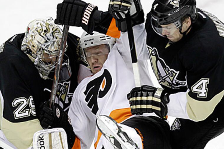 Scott Hartnell collides with Penguins goalie Marc-Andre Fleury and Zbynek Michalek. (AP Photo/Gene J. Puskar)