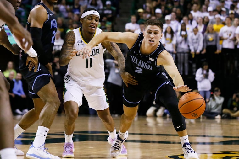 Villanova guard Collin Gillespie (2) reaches for the loose ball in front of Baylor guard James Akinjo (11) during the first half of an NCAA college basketball game on Sunday in Waco, Texas.