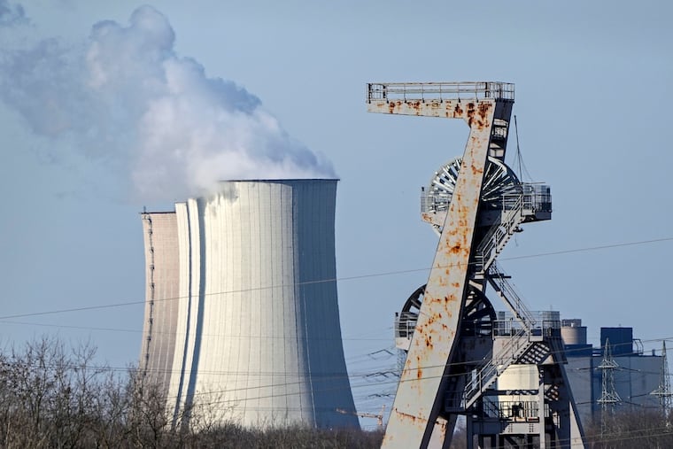 A winding tower of a closed coal mine rusts in front of a coal-fired power station Gelsenkirchen, Germany, on Tuesday.