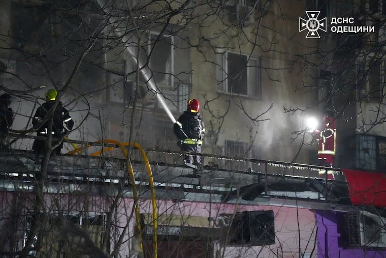In this photo provided by the Ukrainian Emergency Service, emergency services personnel work to extinguish a fire following a Russian attack in Odesa, Ukraine, on Wednesday.