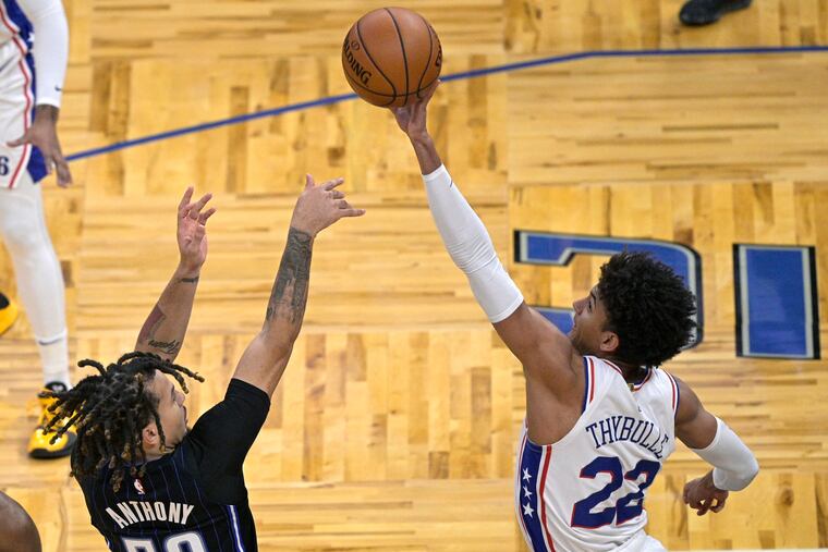 76ers guard Matisse Thybulle (right) blocks a shot by Magic guard Cole Anthony on Thursday.