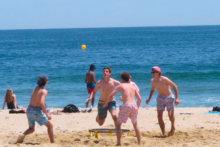 This May 21, 2018, photo shows beachgoers playing spikeball on the sand in Belmar, N.J. New Jersey legislators are trying to enshrine in law the public's right to access and use the state's waterways and adjacent shorelines.