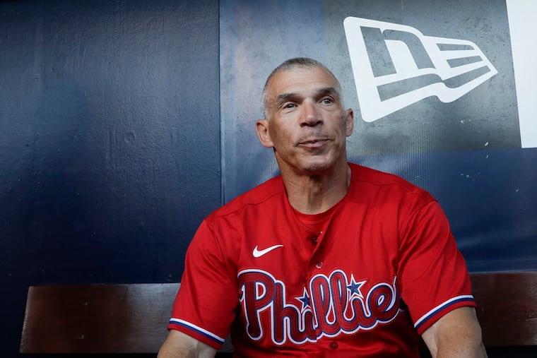 Former Philadelphia Phillies Manager Joe Girardi sits in the visitors dugout while meeting with the media before the Phillies played the New York Yankees in a split squad spring training game in 2020.