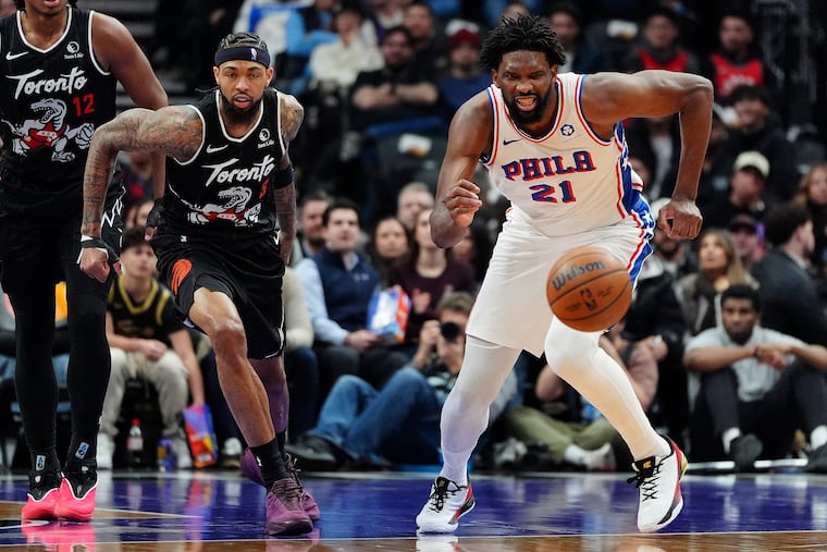 Toronto Raptors forward Brandon Ingram (left) and Joel Embiid vie for a loose ball during first half on Monday.