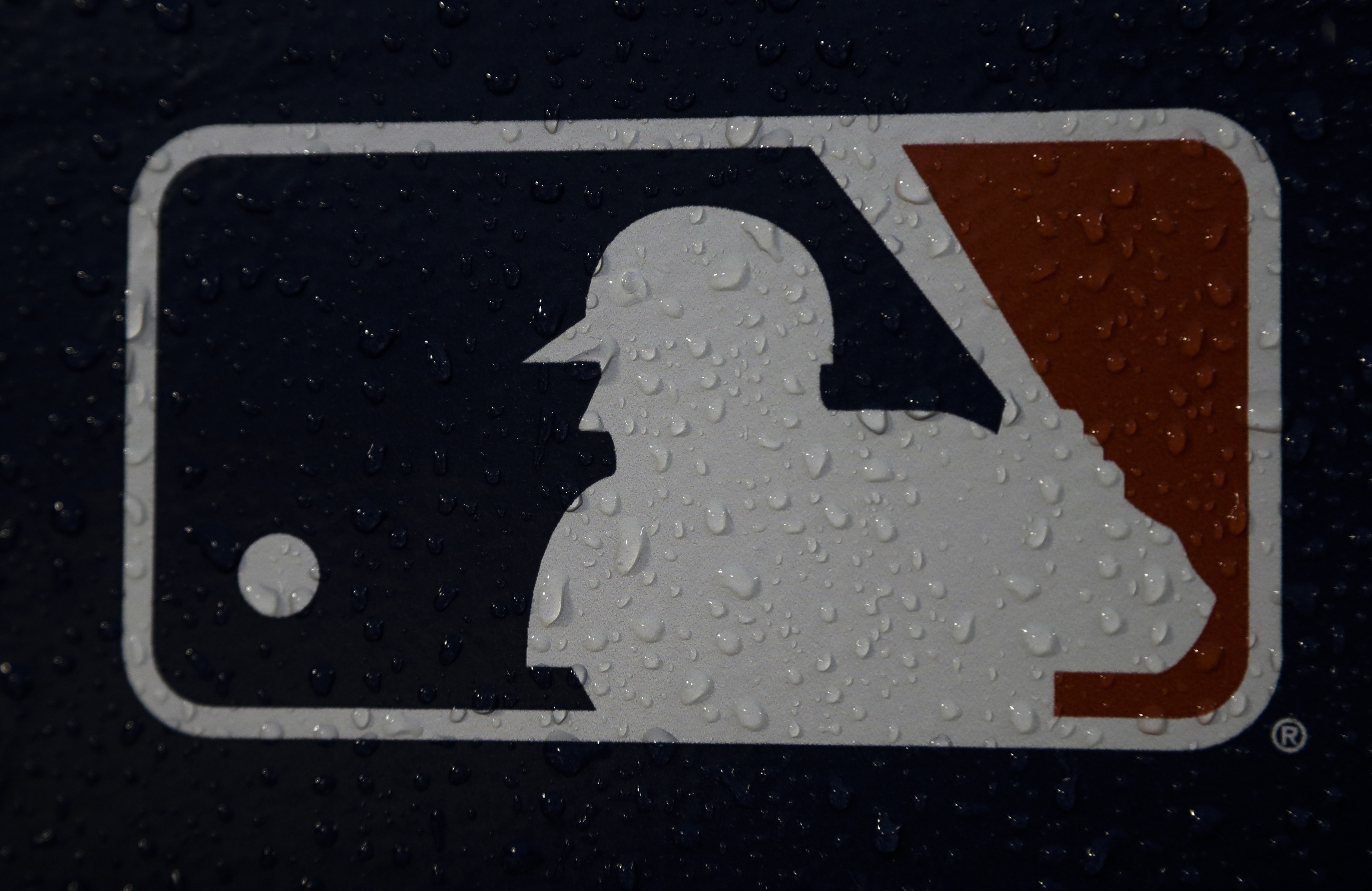A rain-covered logo is seen at Fenway Park in Boston.